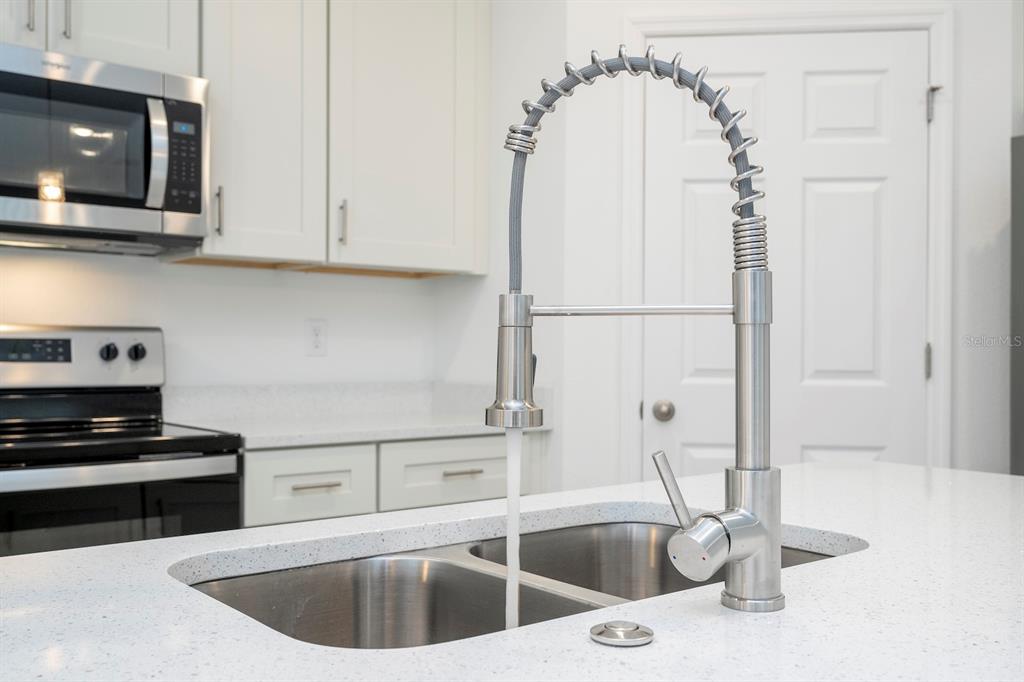 8 Locust Run Ocala, FL 34472 - Photo 11 of 71 a kitchen with stainless steel appliances granite countertop a sink a stove and a microwave