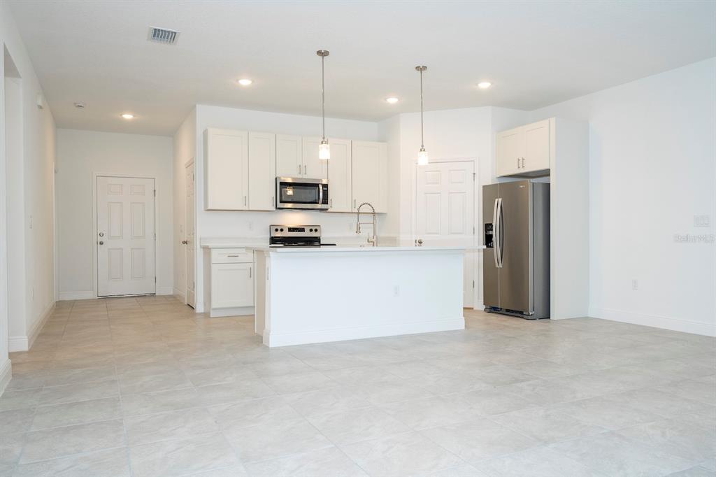 8 Locust Run Ocala, FL 34472 - Photo 22 of 71 a large kitchen with cabinets and stainless steel appliances