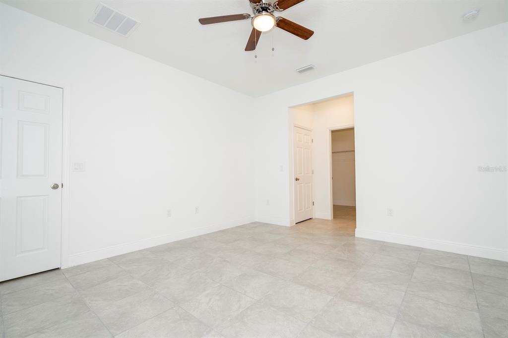 8 Locust Run Ocala, FL 34472 - Photo 33 of 71 an empty room with a ceiling fan and a window