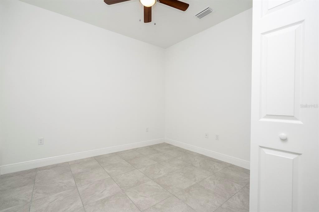 8 Locust Run Ocala, FL 34472 - Photo 57 of 71 an empty room with a ceiling fan and carpet