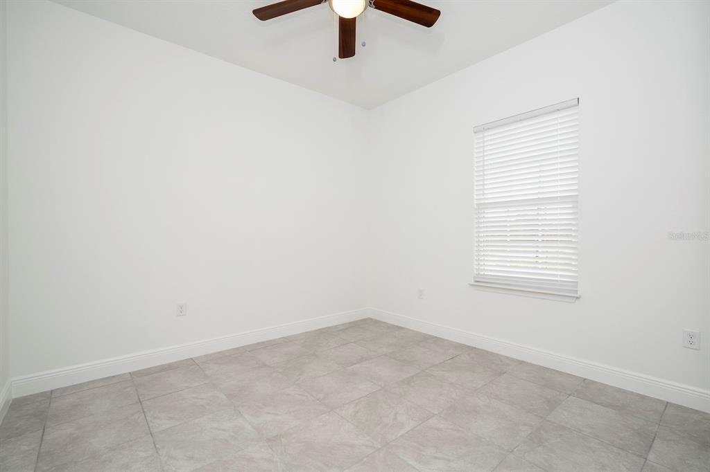 8 Locust Run Ocala, FL 34472 - Photo 60 of 71 an empty room with a window and a ceiling fan