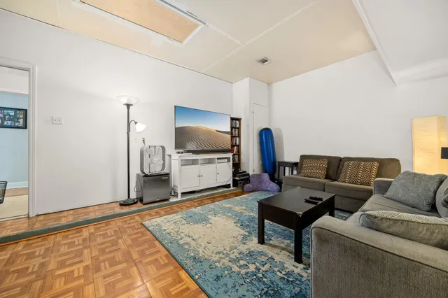 a living room with furniture and kitchen view