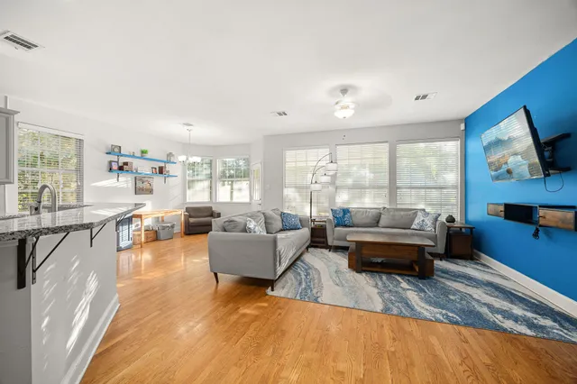 a living room with fireplace furniture and a large window