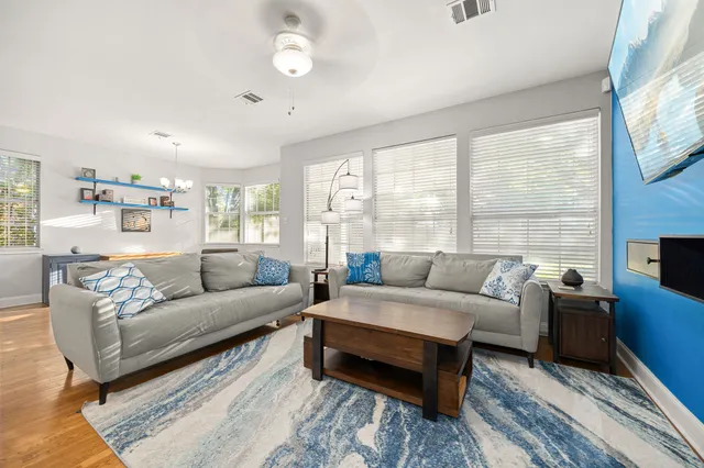 a living room with furniture a fireplace and a large window