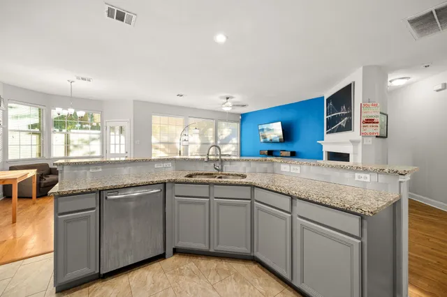 a kitchen with sink stove and cabinets
