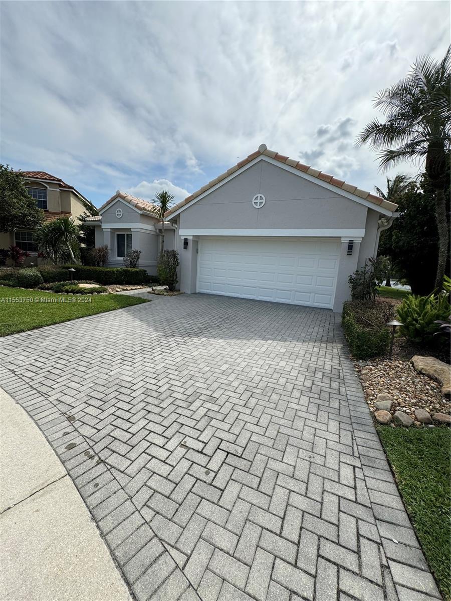 1400 Seabay Road, Unit 1400 Weston, FL 33326 - Photo 1 of 11 a front view of a house with a yard