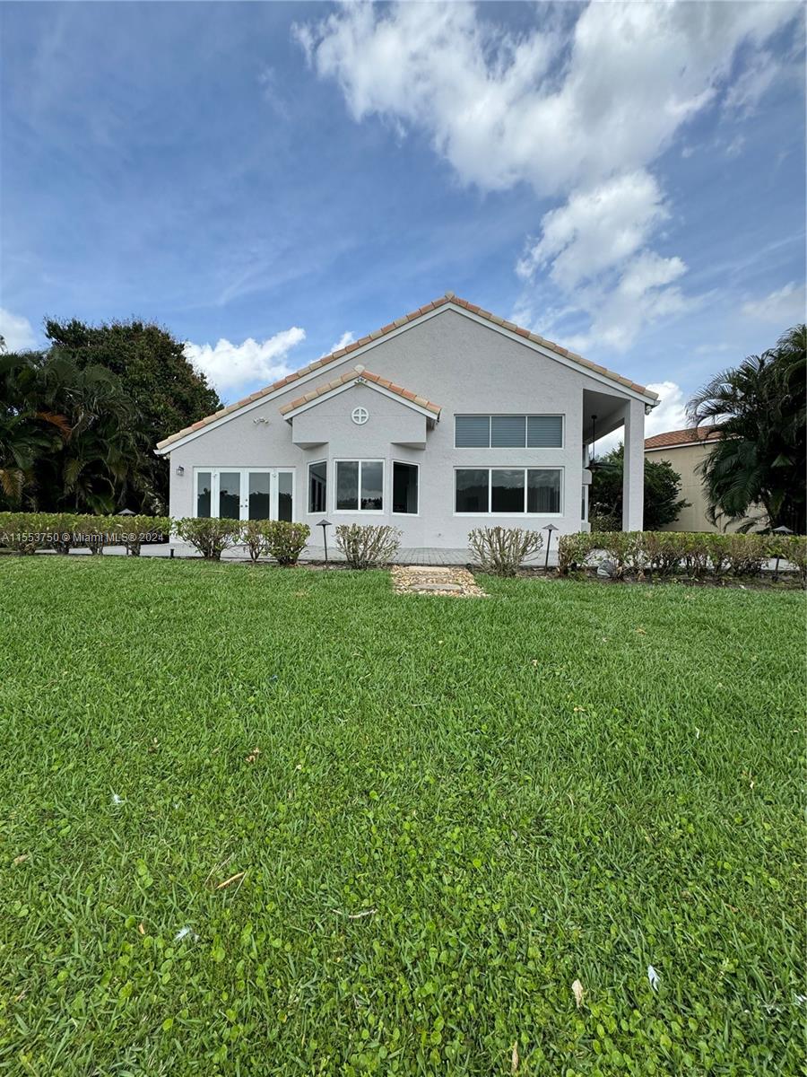 1400 Seabay Road, Unit 1400 Weston, FL 33326 - Photo 2 of 11 a front view of house with yard and green space