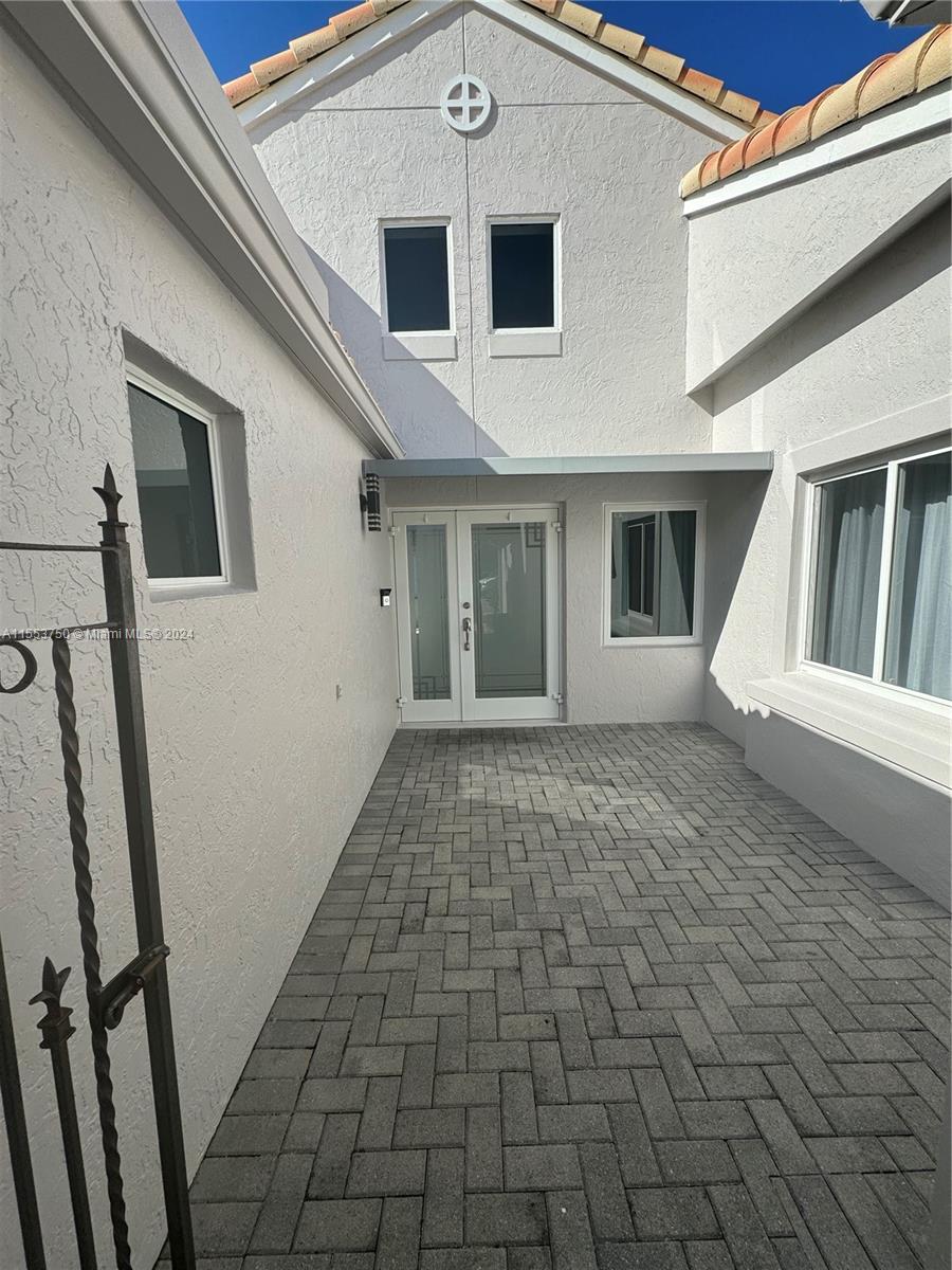 1400 Seabay Road, Unit 1400 Weston, FL 33326 - Photo 6 of 11 a view of a white house with a white door