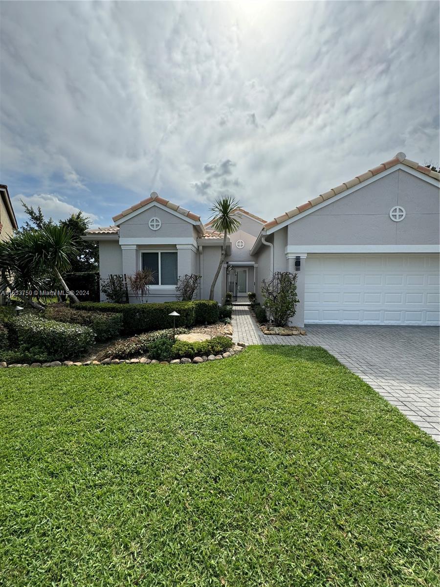 1400 Seabay Road, Unit 1400 Weston, FL 33326 - Photo 8 of 11 a front view of a house with a yard and garage