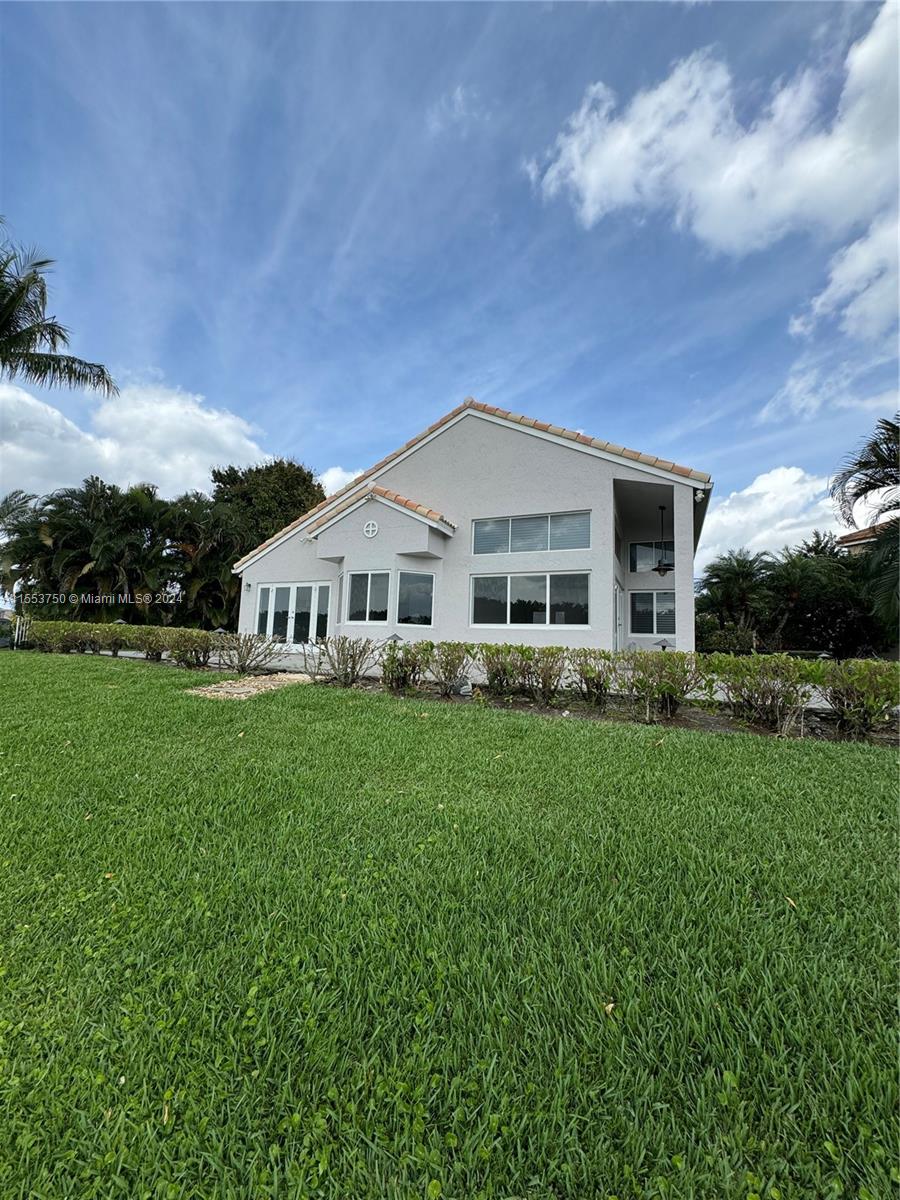 1400 Seabay Road, Unit 1400 Weston, FL 33326 - Photo 10 of 11 a view of a house with backyard and garden