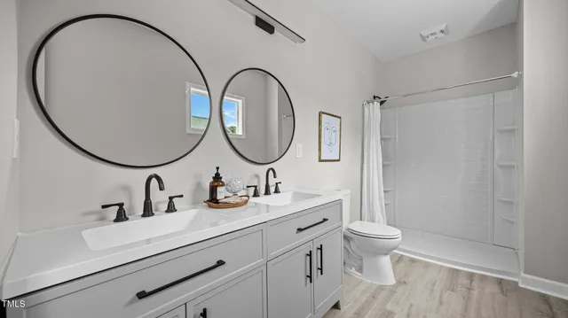 a bathroom with a toilet a sink and a mirror