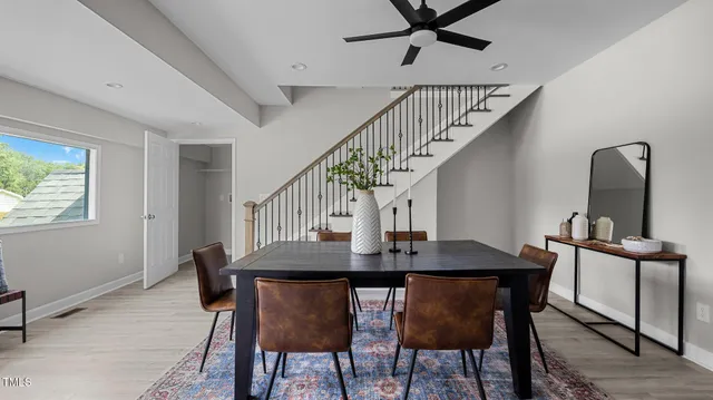 a view of a dining room with furniture and a window