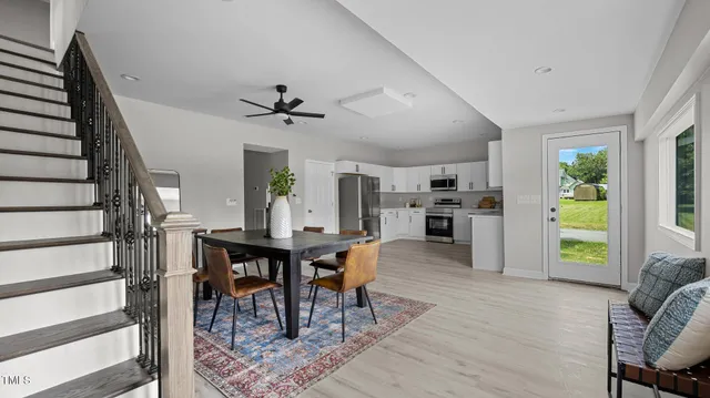 a view of a dining room with furniture and a livingroom