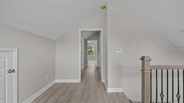 a view of a hallway with wooden floor