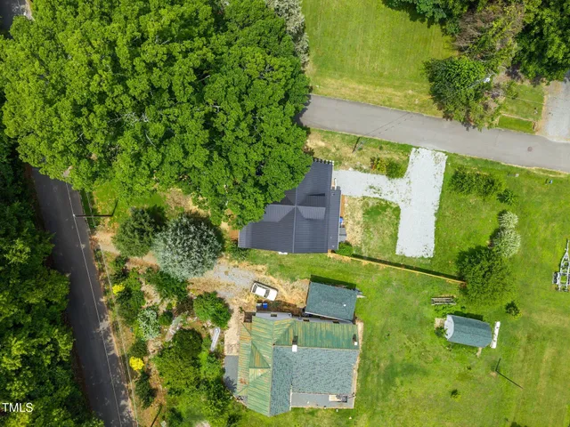an aerial view of a house with a yard