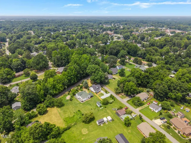 an aerial view of a residential houses with city view