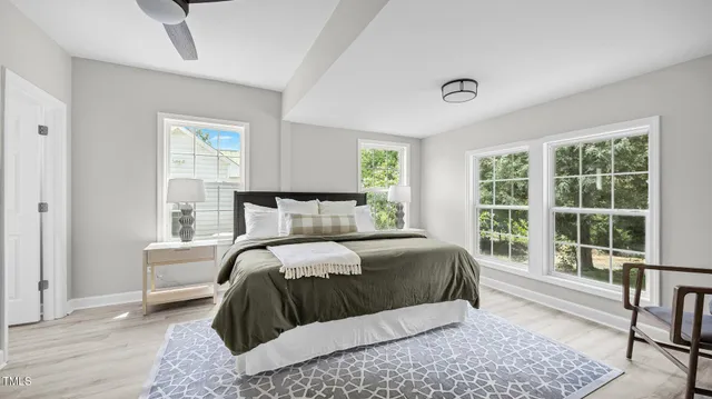 a bedroom with a large bed and a large window