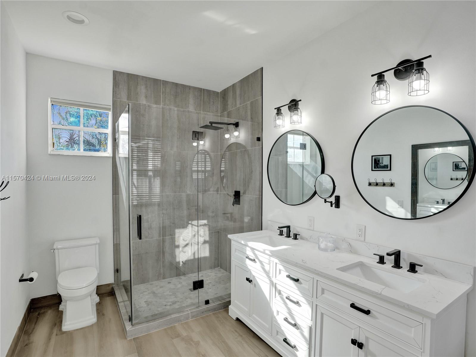 849 Falling Water Road Weston, FL 33326 - Photo 11 of 25 a bathroom with a double vanity sink mirror and shower