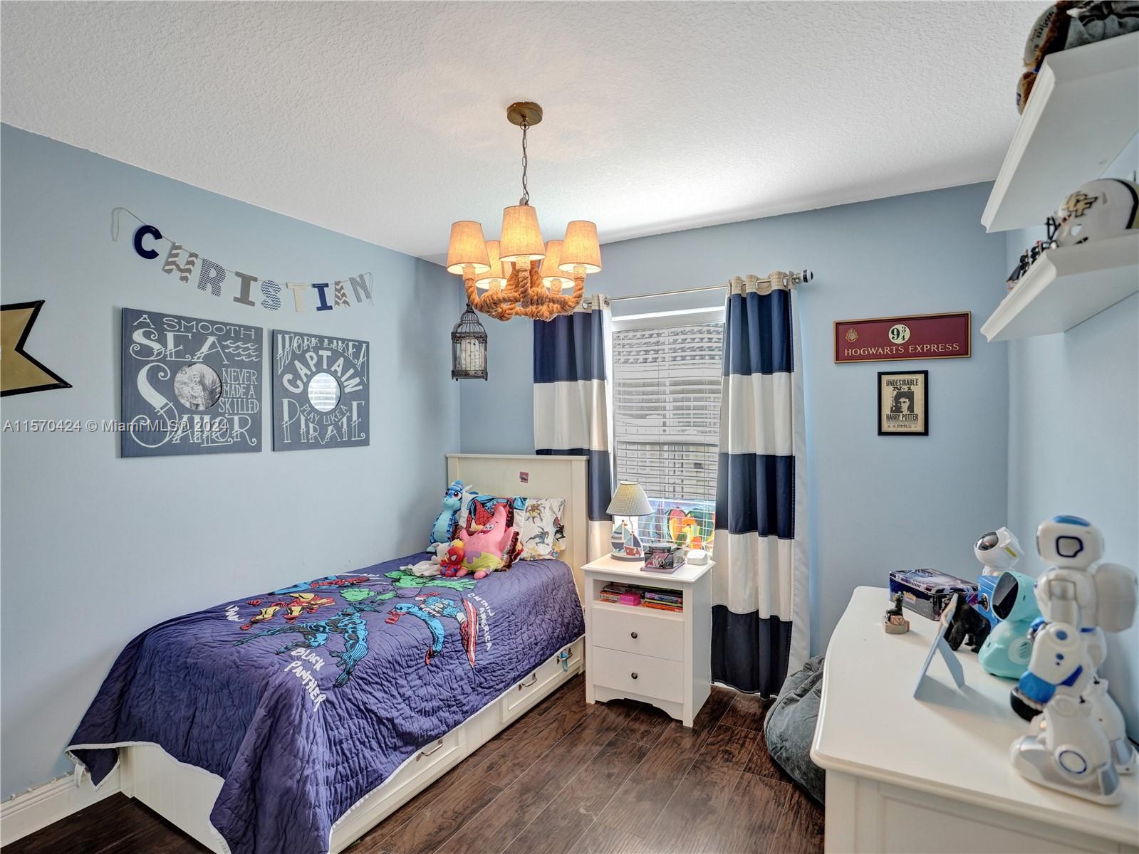 849 Falling Water Road Weston, FL 33326 - Photo 13 of 25 a bed room with a bed and a baby bed