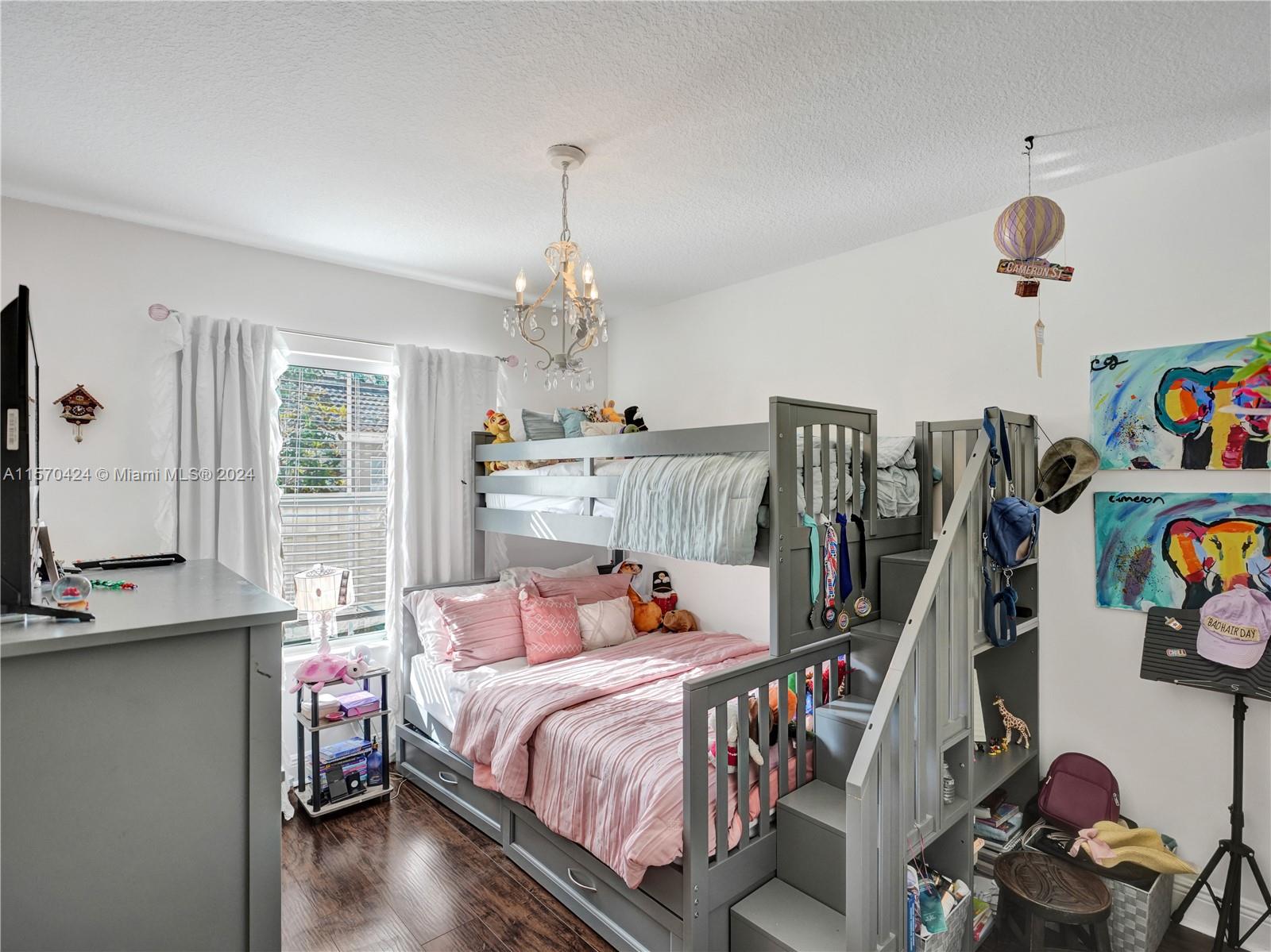 849 Falling Water Road Weston, FL 33326 - Photo 14 of 25 a bedroom with a bed and a chandelier