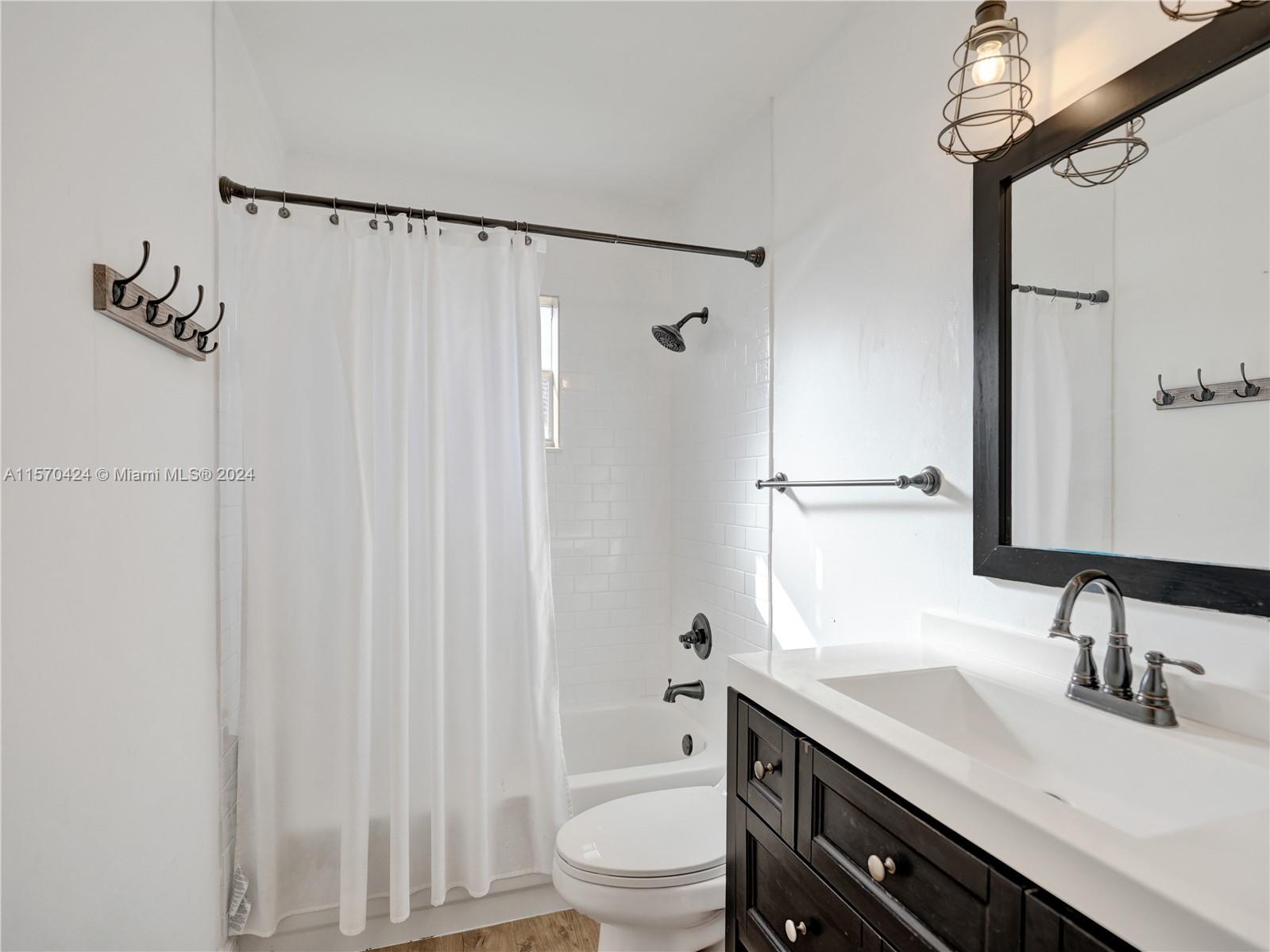 849 Falling Water Road Weston, FL 33326 - Photo 15 of 25 a bathroom with a granite countertop sink toilet and shower