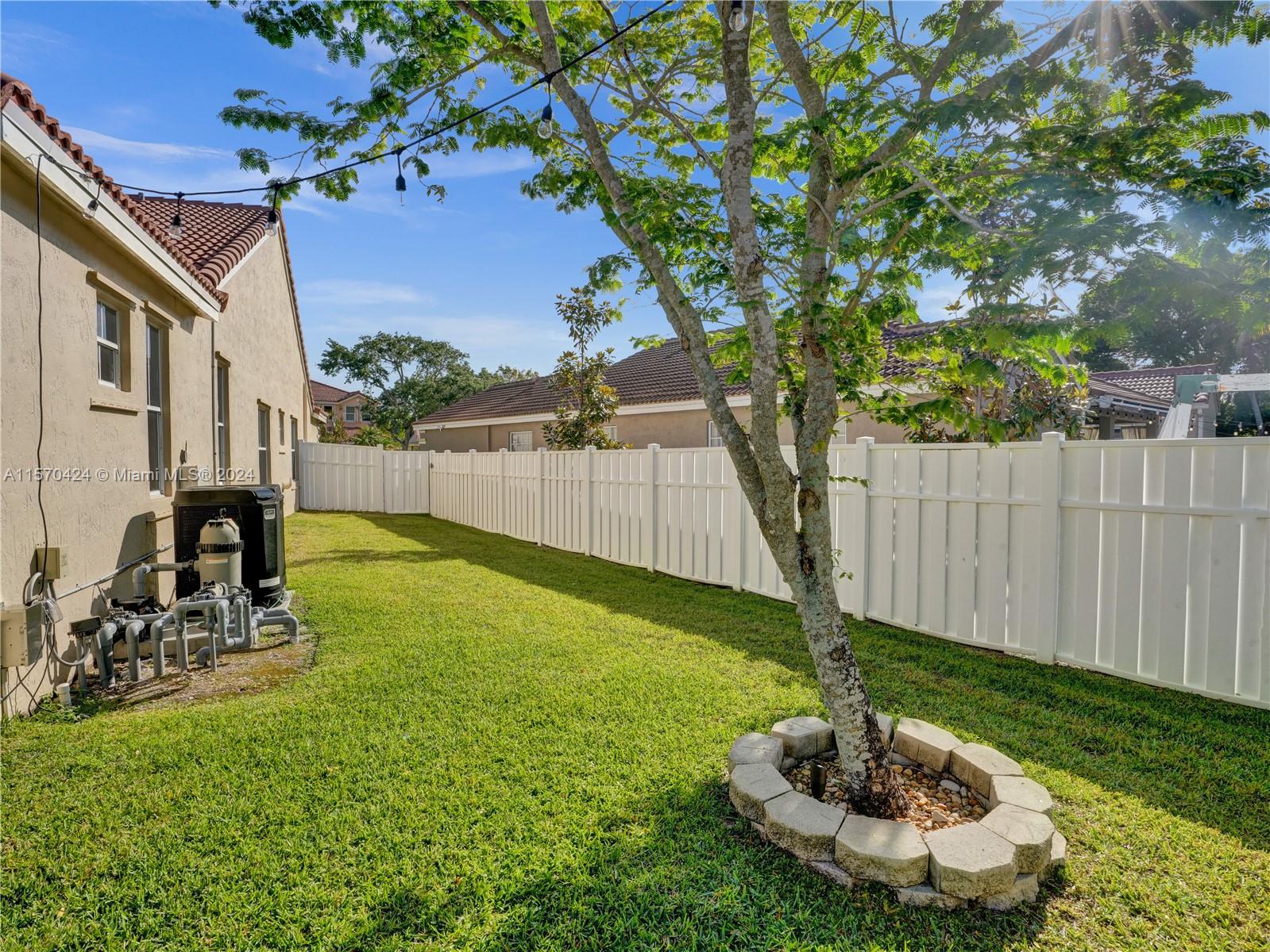 849 Falling Water Road Weston, FL 33326 - Photo 24 of 25 a view of a backyard with plants and a tree