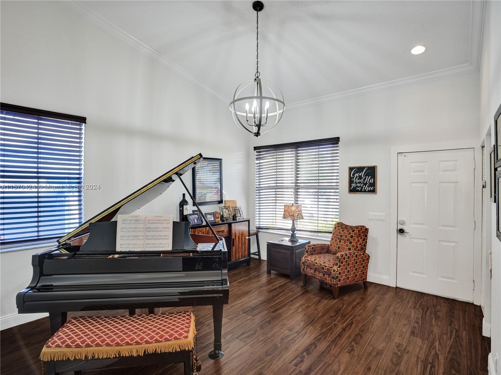 849 Falling Water Road Weston, FL 33326 - Photo 3 of 25 a living room with furniture and a chandelier
