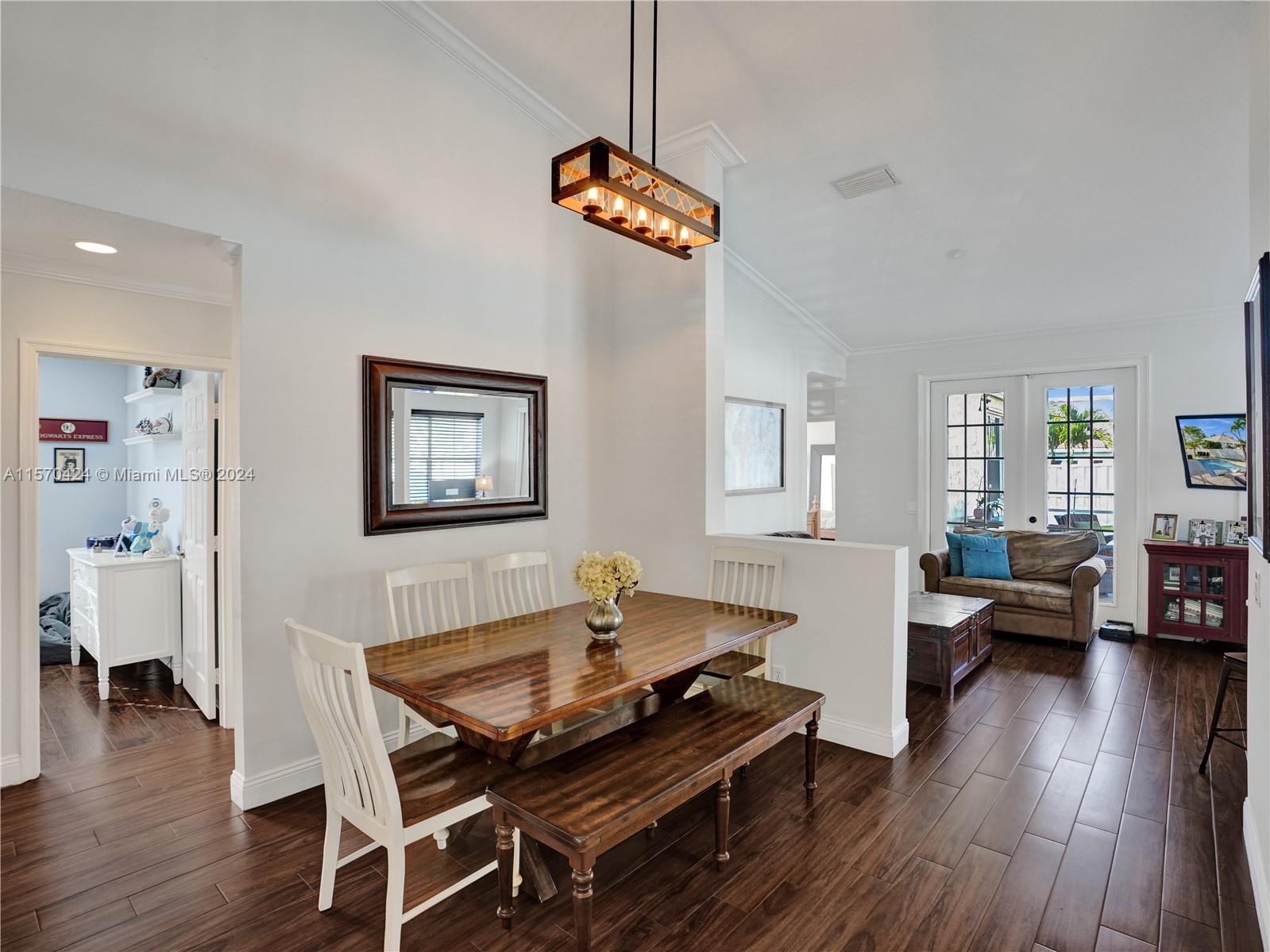 849 Falling Water Road Weston, FL 33326 - Photo 4 of 25 a living room with dining room and wooden floor