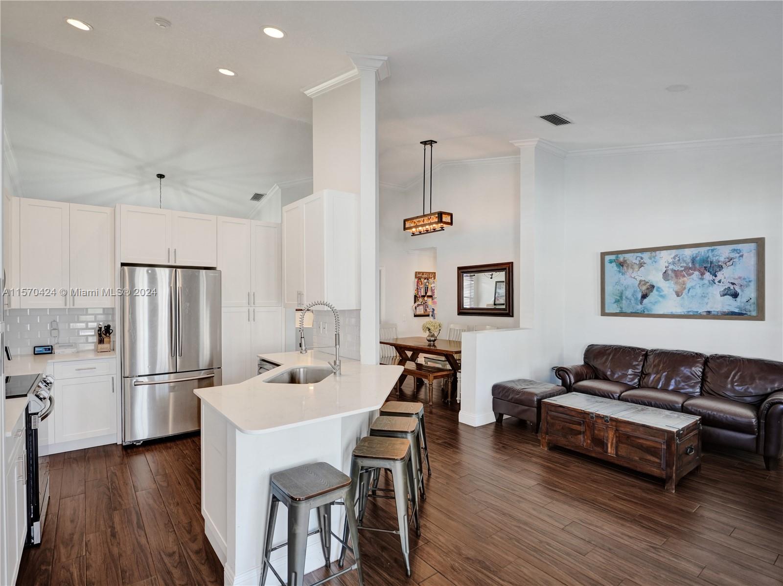 849 Falling Water Road Weston, FL 33326 - Photo 6 of 25 a living room with stainless steel appliances furniture and a wooden floor