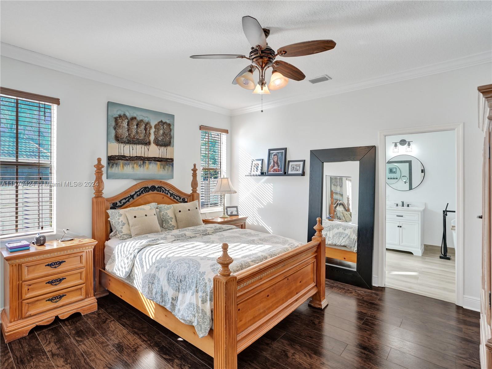 849 Falling Water Road Weston, FL 33326 - Photo 9 of 25 a bedroom with a bed and a chandelier