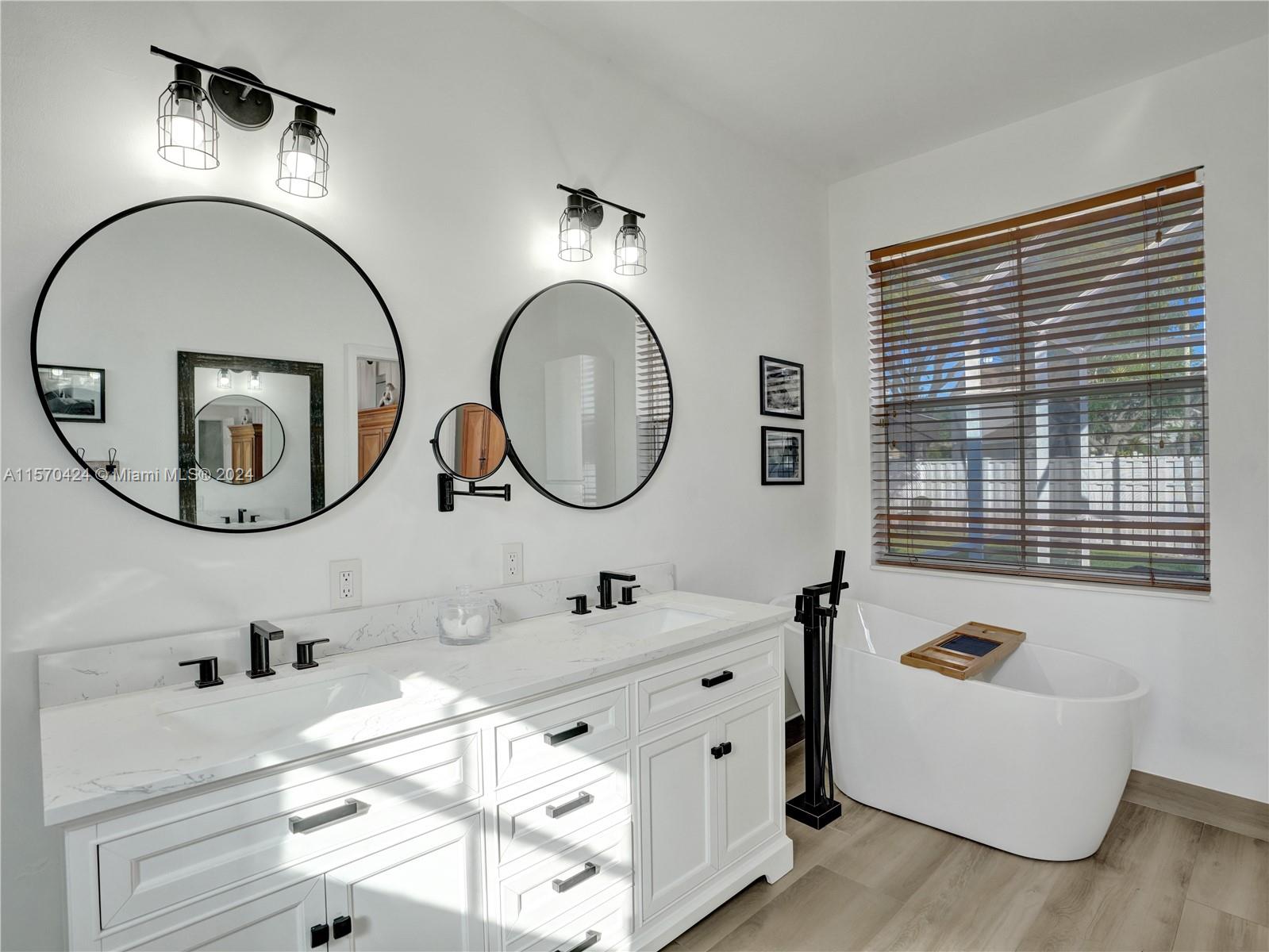 849 Falling Water Road Weston, FL 33326 - Photo 10 of 25 a bathroom with a tub mirror and sink