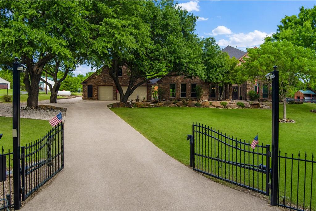 1820 Winningkoff Road Lucas, TX 75002 - Photo 1 of 40 Welcome to 1820 Winningkoff Dr., a gorgeous estate featuring a private gated entrance, mature trees, and a long drive leading to a serene, retreat-like setting.