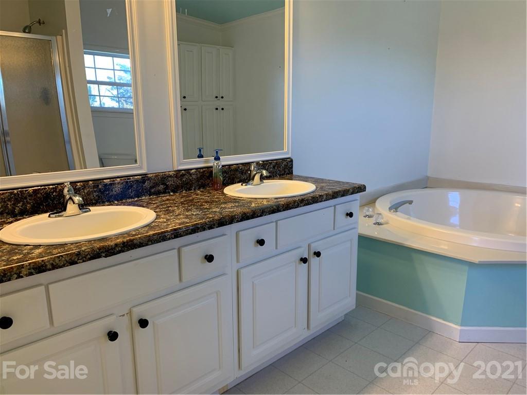 3801 Whiteside Road Bostic, NC 28018 - Photo 22 of 29 a bathroom with a granite countertop sink and mirror
