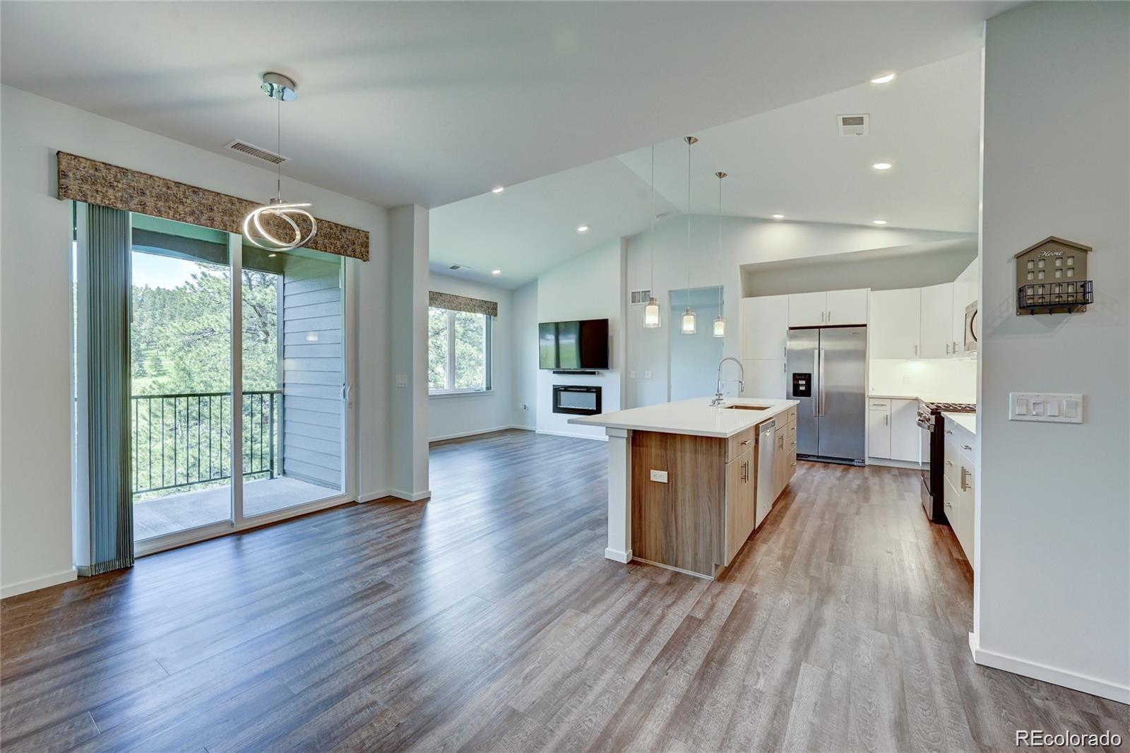 31191 Black Eagle Drive, Unit 301 Evergreen, CO 80439 - Photo 11 of 35 a view of kitchen with cabinets and wooden floor