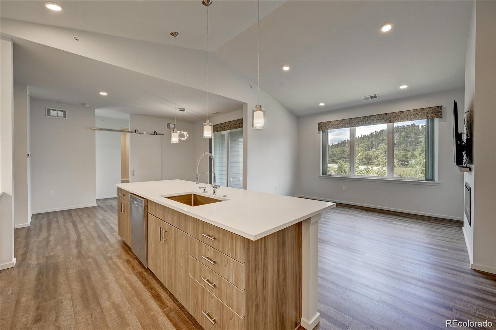 31191 Black Eagle Drive, Unit 301 Evergreen, CO 80439 - Photo 12 of 35 an open kitchen with a sink and dish washer