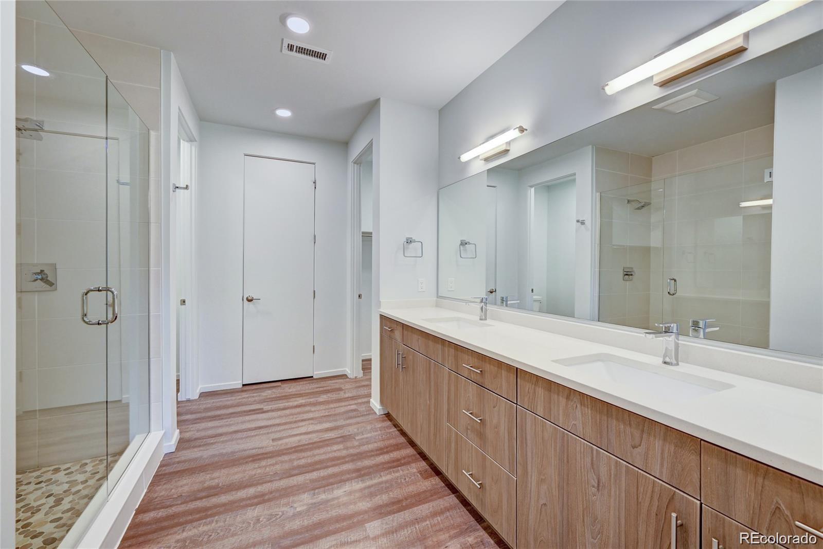 31191 Black Eagle Drive, Unit 301 Evergreen, CO 80439 - Photo 17 of 35 a spacious bathroom with a double vanity sink mirror and shower