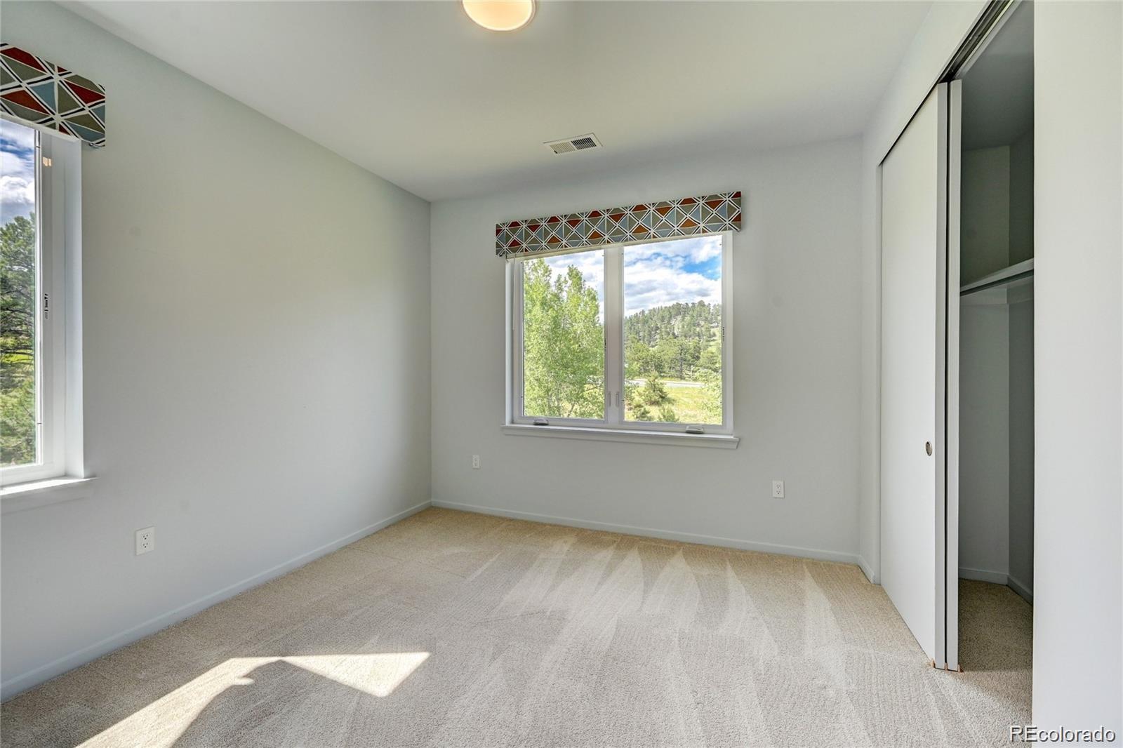 31191 Black Eagle Drive, Unit 301 Evergreen, CO 80439 - Photo 20 of 35 an empty room with a window