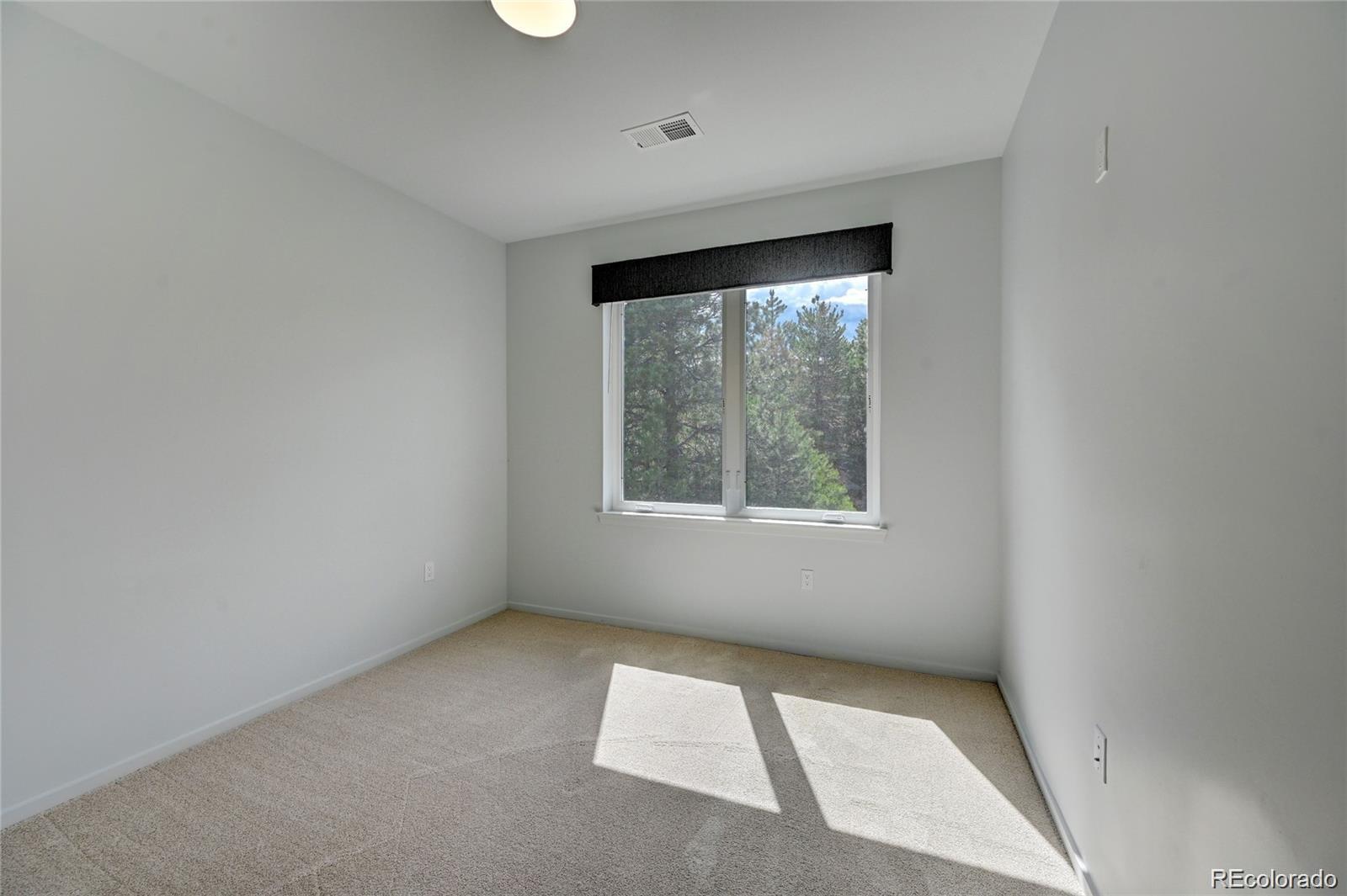 31191 Black Eagle Drive, Unit 301 Evergreen, CO 80439 - Photo 23 of 35 an empty room with a window