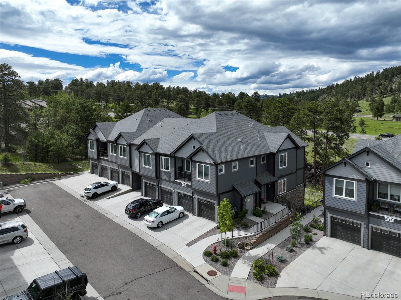 31191 Black Eagle Drive, Unit 301 Evergreen, CO 80439 - Photo 27 of 35 front view of a house with a garden