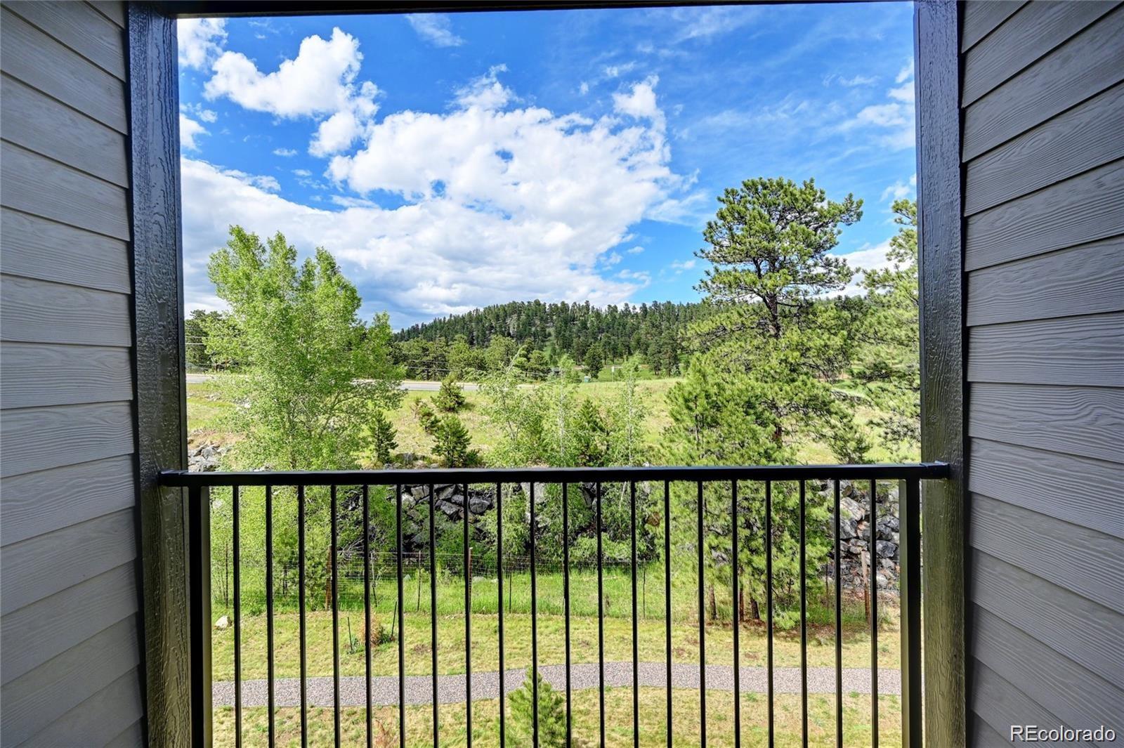 31191 Black Eagle Drive, Unit 301 Evergreen, CO 80439 - Photo 28 of 35 a view of a balcony with wooden fence