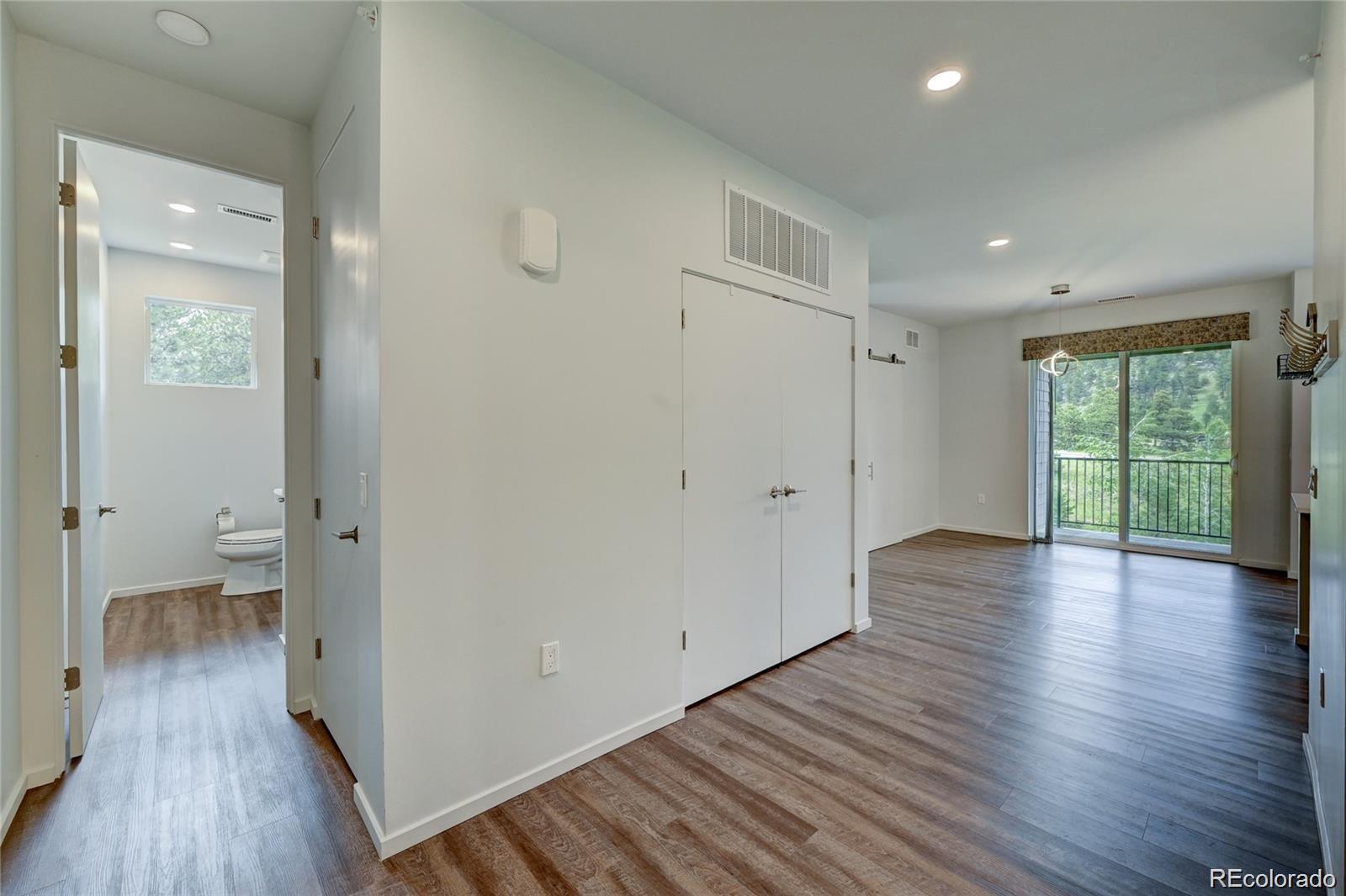 31191 Black Eagle Drive, Unit 301 Evergreen, CO 80439 - Photo 3 of 35 wooden floor in an empty room with a window