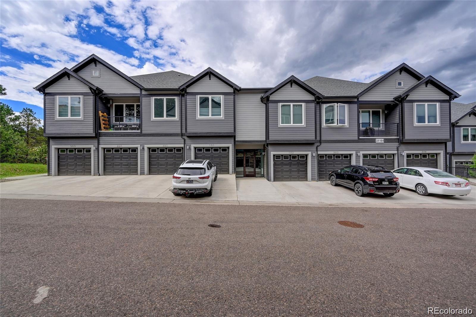 31191 Black Eagle Drive, Unit 301 Evergreen, CO 80439 - Photo 34 of 35 a car parked in front of a white house