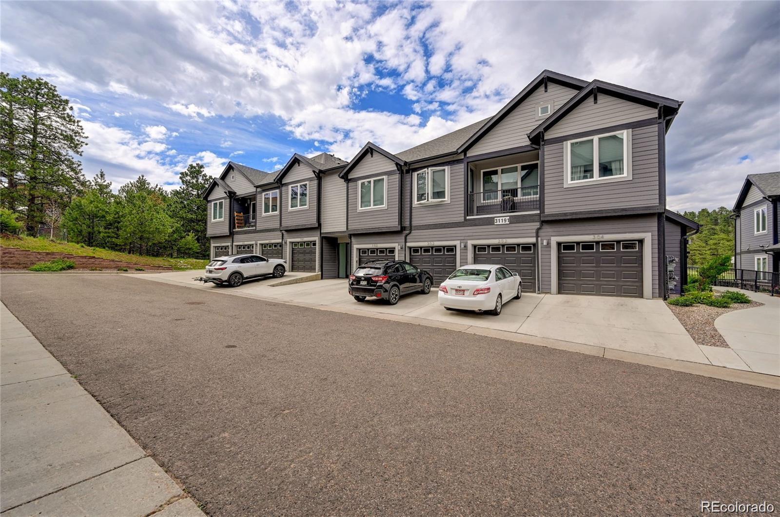 31191 Black Eagle Drive, Unit 301 Evergreen, CO 80439 - Photo 35 of 35 a car parked in front of a house