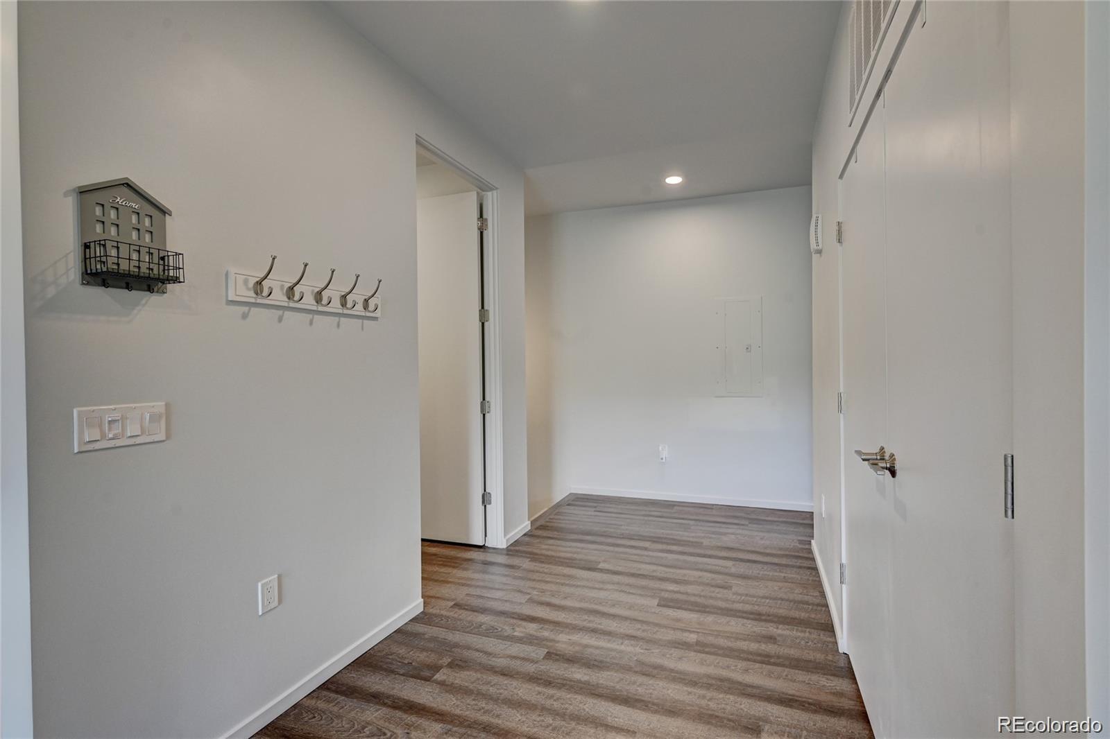 31191 Black Eagle Drive, Unit 301 Evergreen, CO 80439 - Photo 4 of 35 a view of a hallway with wooden floor
