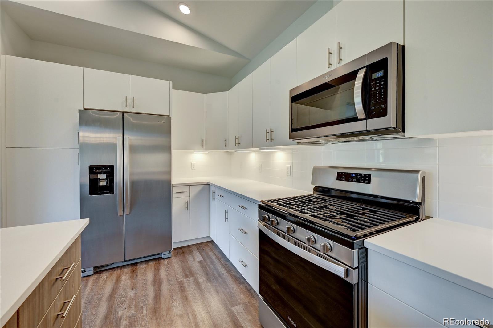 31191 Black Eagle Drive, Unit 301 Evergreen, CO 80439 - Photo 9 of 35 a kitchen with cabinets and steel stainless steel appliances