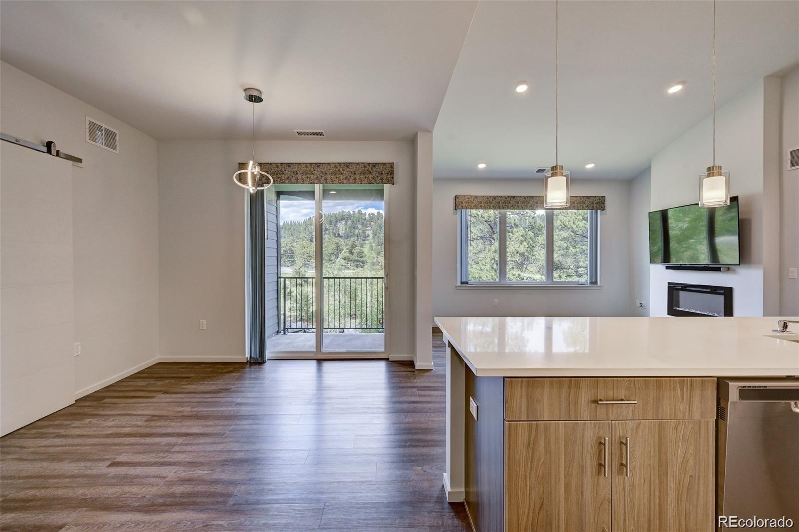 31191 Black Eagle Drive, Unit 301 Evergreen, CO 80439 - Photo 10 of 35 an entryway with wooden floor and garden