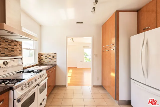 a kitchen with a stove a refrigerator and a stove