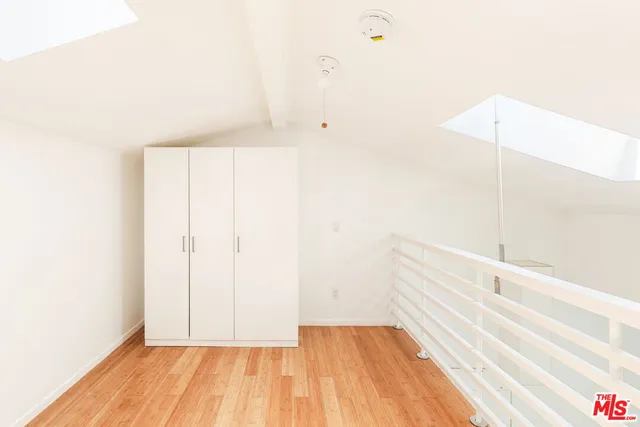 a view of a room with wooden floor