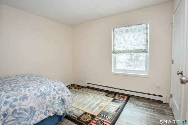 a bed sitting in a bedroom next to a window