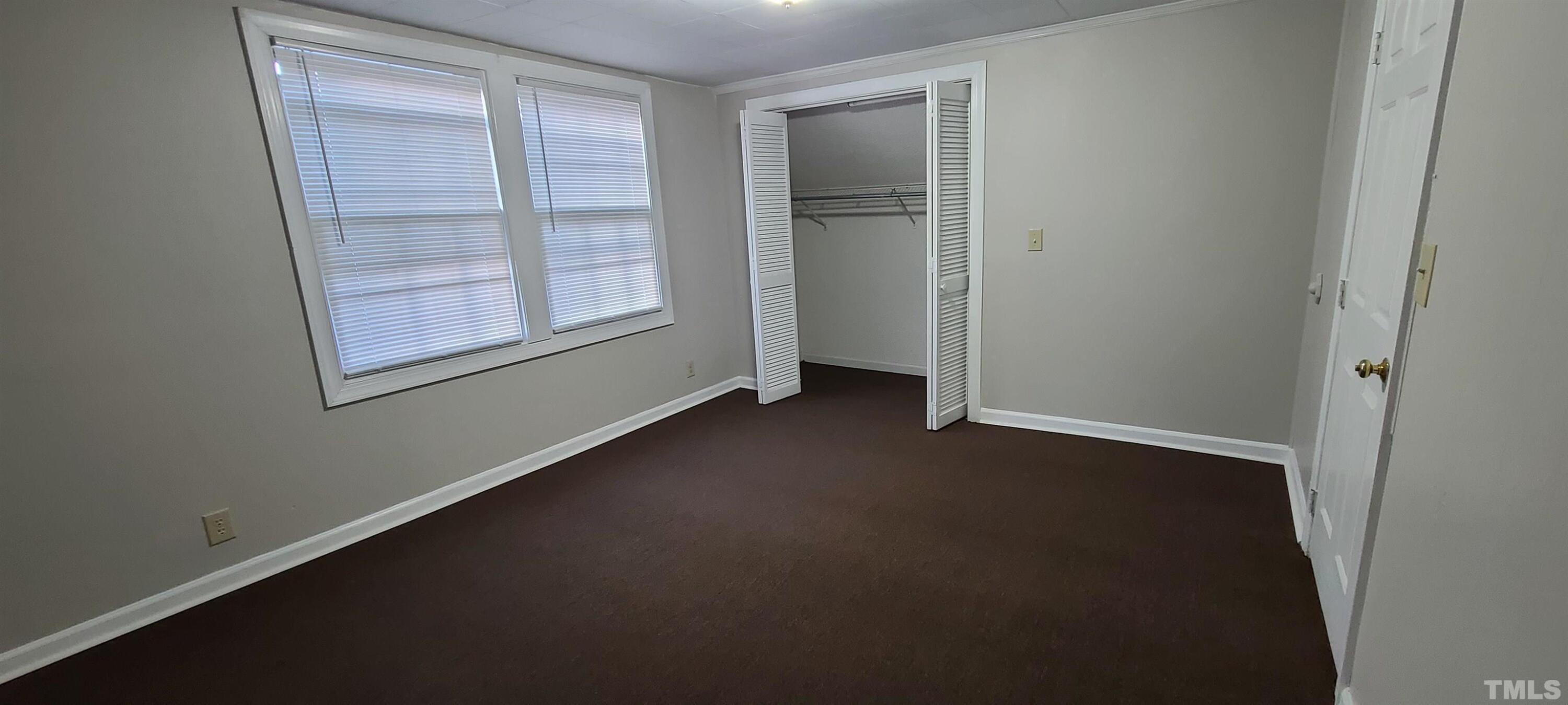 318 Powell Drive, Unit 2 Raleigh, NC 27606 - Photo 7 of 10 an empty room with windows